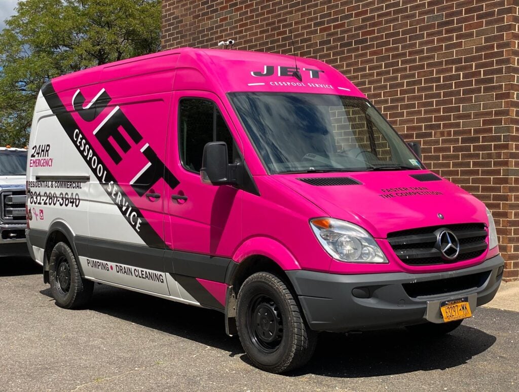 Pink JET Cesspool Service van with the 24-hour emergency number