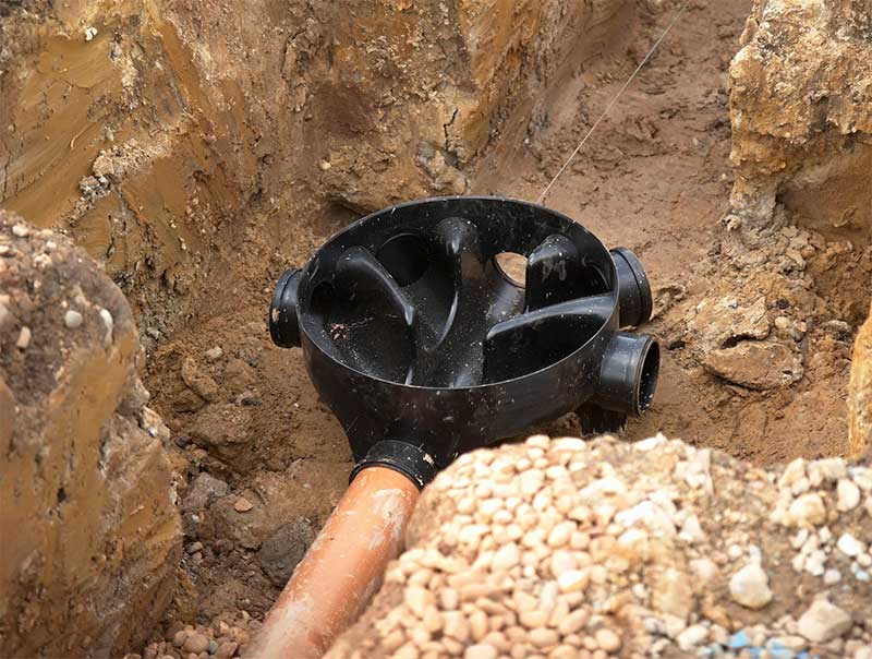 New drain pipe junction installed in an excavation