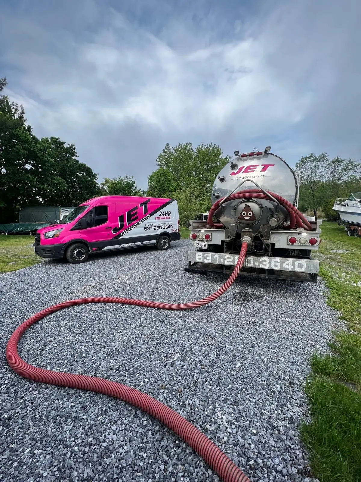 JET pump truck with its hose run out and a JET service van on a Long Island job site